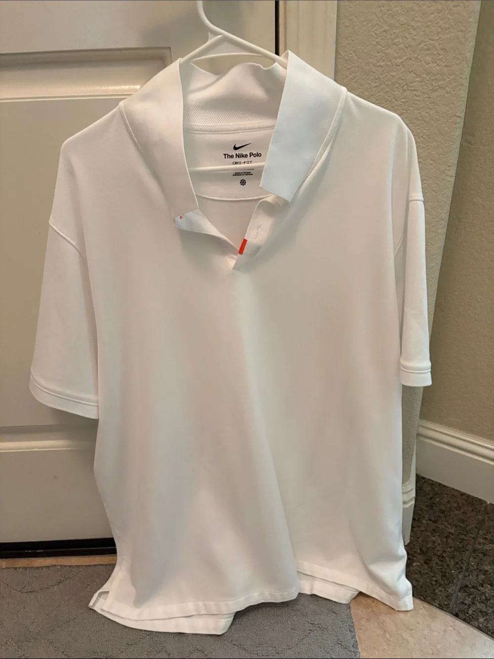 Nike White Kids Polo Shirt with Subtle Orange Tab